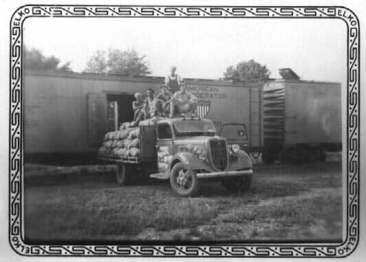 POWs loading sacks of potatoes onto a train near Independence, Missouri. 1944.